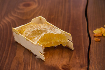 honey in honeycomb on wooden background