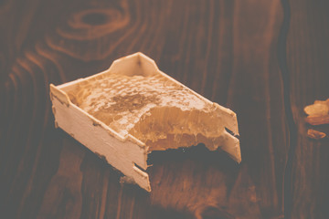 honey in honeycomb on wooden background