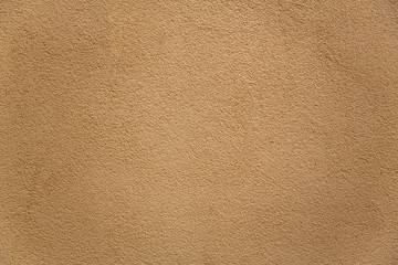 gray beige porous granular wall with shadows. rough surface texture