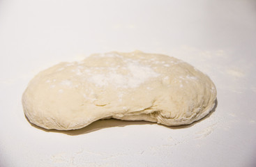 Fototapeta na wymiar dough with flour on a white background