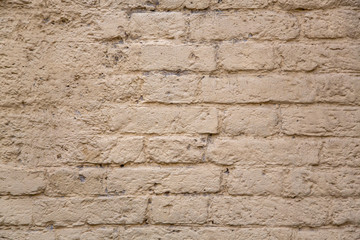 old gray beige brick wall with damaged cement. rough surface texture