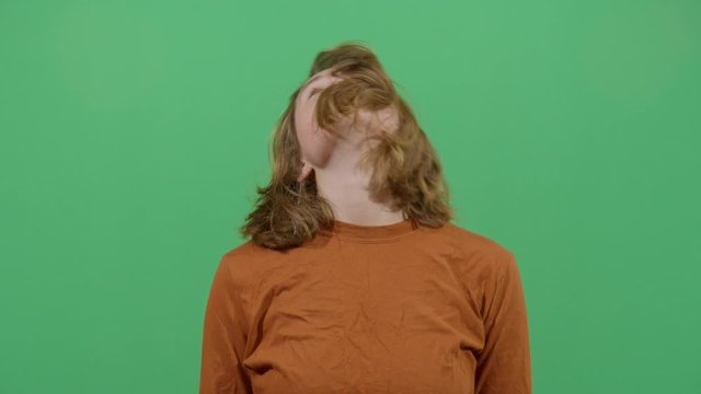 Woman Head Turning Like A Sign Of Stress Or Trying To Relax A Tired Body. Studio Isolated Shot Against Green Screen Background
