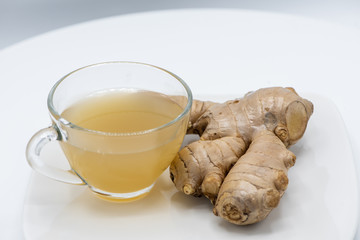 Ginger juice fresh in a glass cup on white background for healthy.