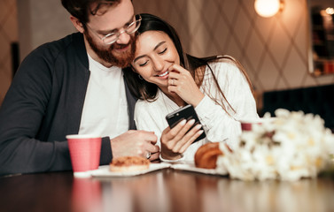 Loving couple browsing social media during date