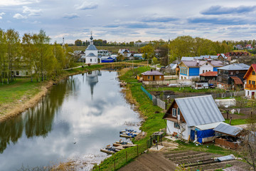 Wooden houses along the Kamenka river in Suzdal, a well preserved old Russian town-museum. A member...