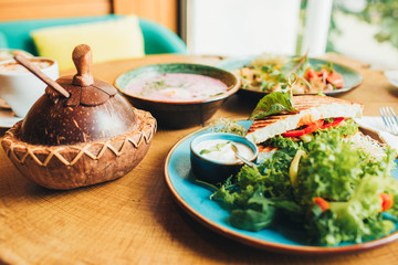 Vegan and vegetarian food. Variety of dishes on a wooden table, top view, flat lay, kitchen items.