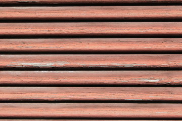 Close up of old weathered red window shutter