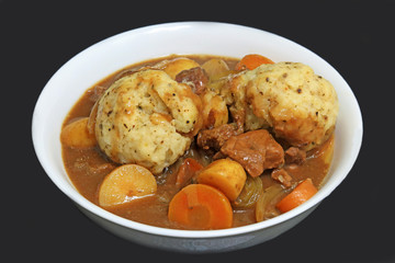 Herb Flavoured Suet Dumplings In A Bowl Of Beef Casserole.