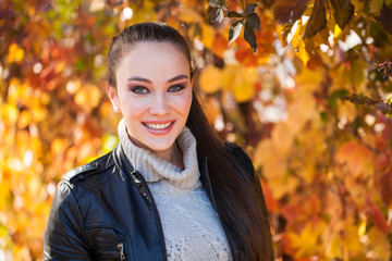 Portrait of a young beautiful model in a black leather jacket