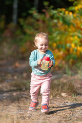 Adorable girl having fun on beautiful autumn day. authentic childhood image.