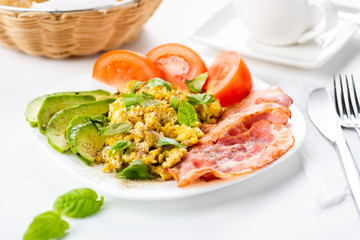 bacon and eggs with avocado and tomato, bread and coffee