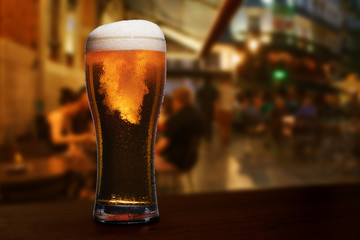 glass of beer on a street bar table.