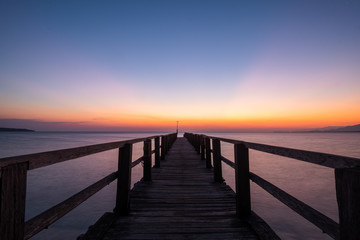 Fototapeta na wymiar Sunrise at Bali Nation Park, at the beach with pier