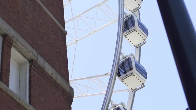 Slow motion Panning Up shot of the SkyView Ferris Wheel in use in Georgia, Atlanta.
