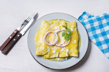 Mexican green enchiladas with melted cheese also called 