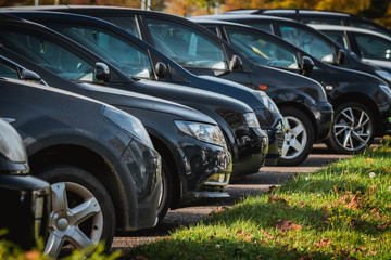 Obraz na płótnie Canvas cars row parked at a car dealership stock