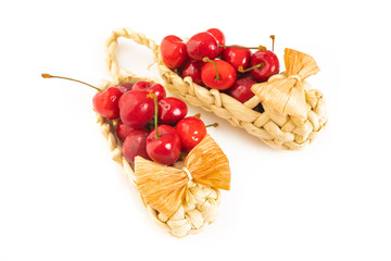 Cherry in basket isolated on white background