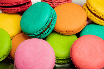 Fototapeta na wymiar French Colorful Macarons on Pink Background