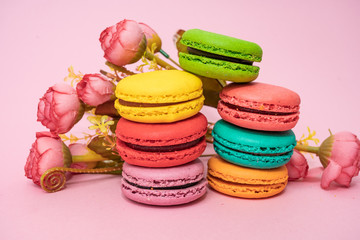 macarons with tender small roses. Sweets and desserts concept of macaroons