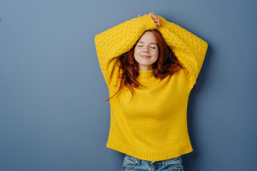 Satisfied young woman relaxing with closed eyes