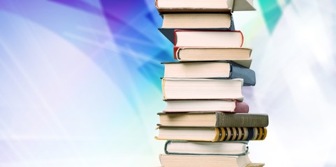 Collection of old books vertical stack on beige background