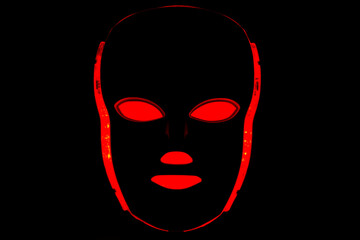 Color therapy mask glowing red dark background