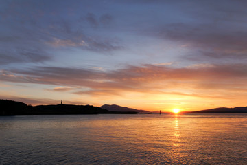 Fototapeta na wymiar Sunset over Oban Bay and the entrance to Oban harbour