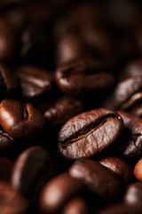 Close up of roasted coffee beans for background, texture and design. Selective focus.