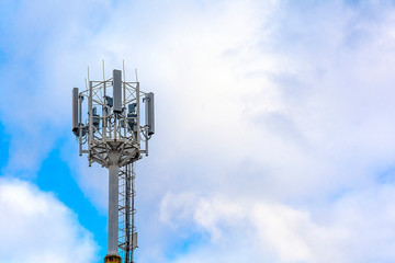Cellular communication tower on a background of cloudy sky. Soft focus. Concept: communication and...