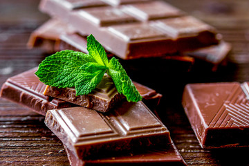 black and milk chocolate bars dark wooden table background