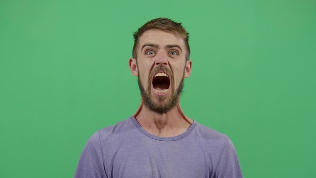 Adult Man Opening And Closing The Mouth Looking At The Camera. Studio Isolated Shot Against Green Screen Background
