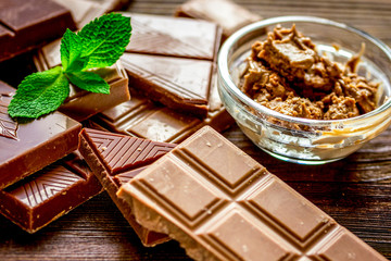 chocolate pieces with mint on wooden table background