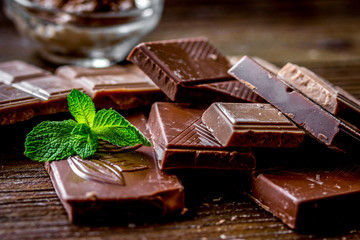 chocolate pieces with mint on wooden table background