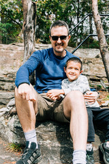 Father and Son Portrait Sitting Outside