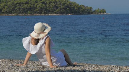 Young beautiful woman with white hat relax on beach