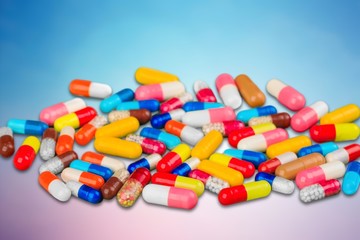 Colorful pills and tablets on background