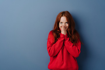 Cute young redhead woman with a shy smile - obrazy, fototapety, plakaty