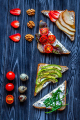 fitness breskfast with homemade sandwiches dark table background top view