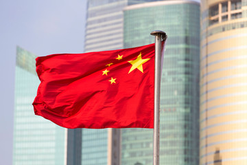 China's flag on the background of skyscrapers of Shanghai World Financial Center