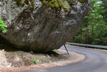a rock supported with a stick of wood