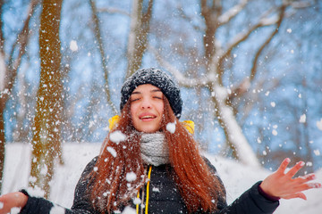 Fototapeta na wymiar Moments of happiness and joy. Attractive young woman in wintertime outdoor