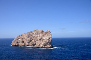 view of single rock in sea