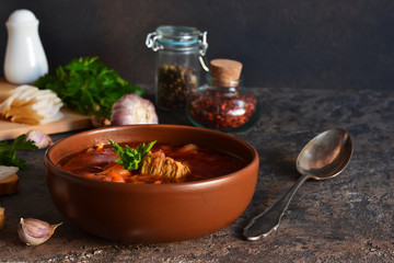 Borsch - a national dish of Russian cuisine with lard on the kitchen table. Vegetable soup with beets and meat.