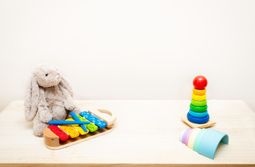 Background of Colorful Children's toys against the wall Toys on Wood Table with Copy Space for Text