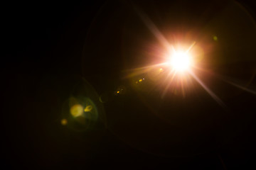 abstract lens flare red light over black background