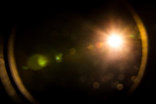 abstract lens flare red light over black background
