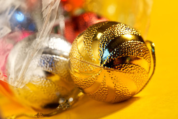Christmas tree toys are removed from the packaging for decorations. Preparing for the New Year holidays. Macro. Bokeh, volume and shallow depth of field