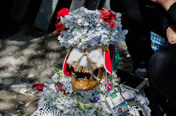 The photograph shows a human skull at a Bolivian party where death is venerated