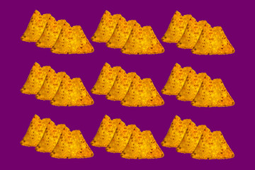 Naklejka premium Three each bitten nachos on violet color background