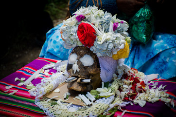 The photograph shows a human skull at a Bolivian party where death is venerated